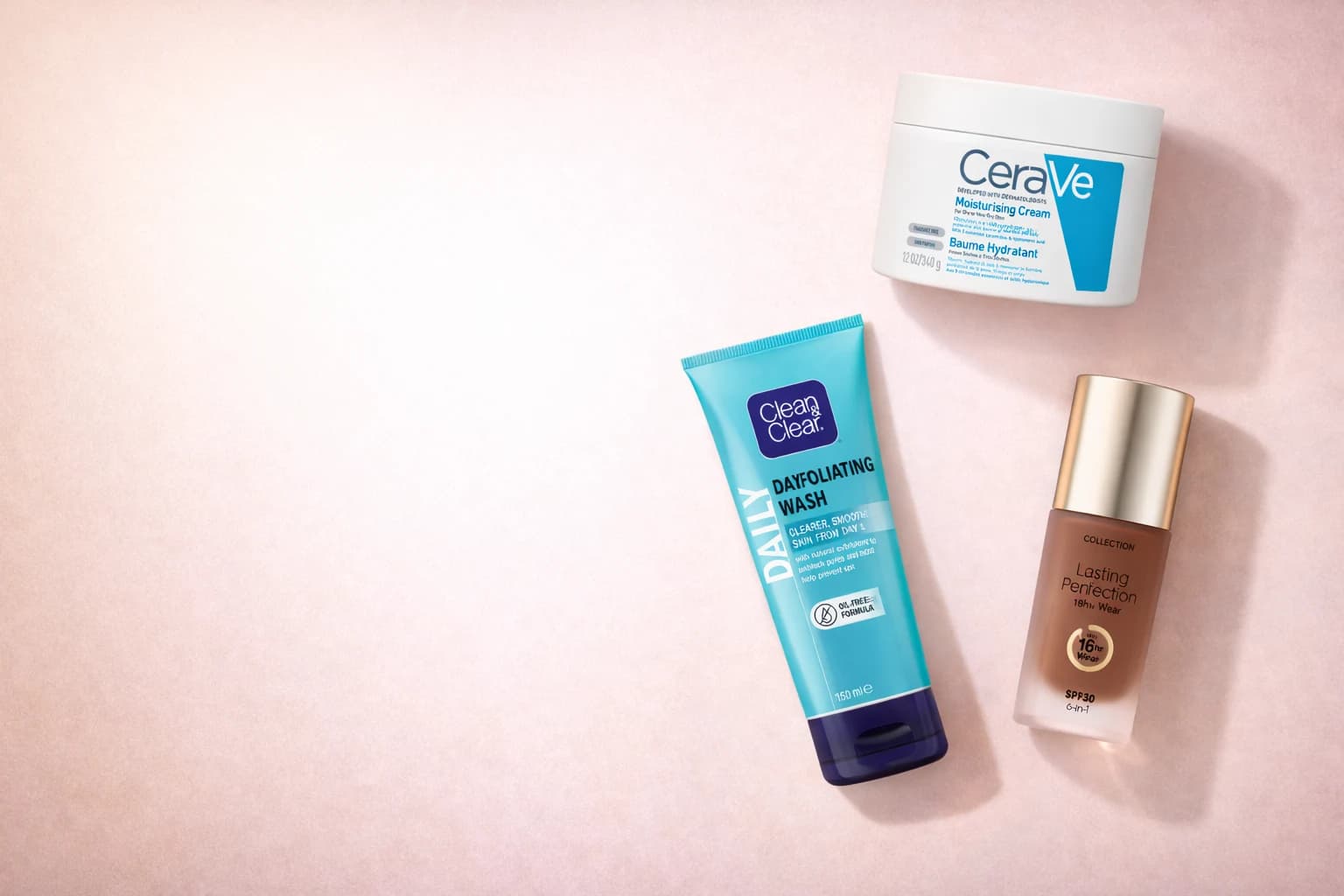 Beauty and skincare products arranged on a soft pink background